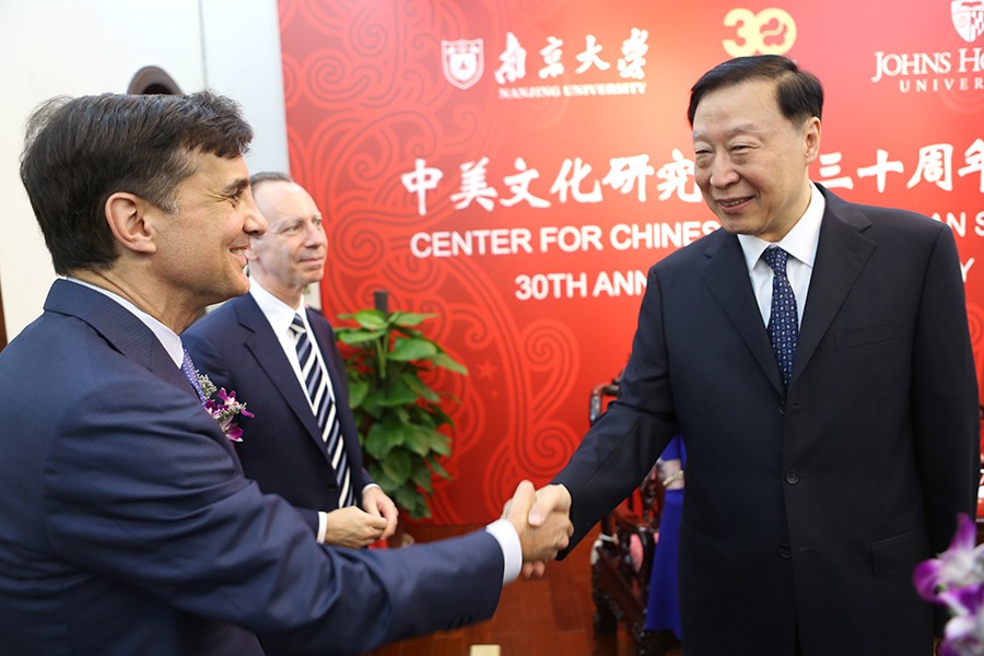 JHU President Ronald J. Daniels and Chen Deming, former Chinese Minister of Commerce, shake hands