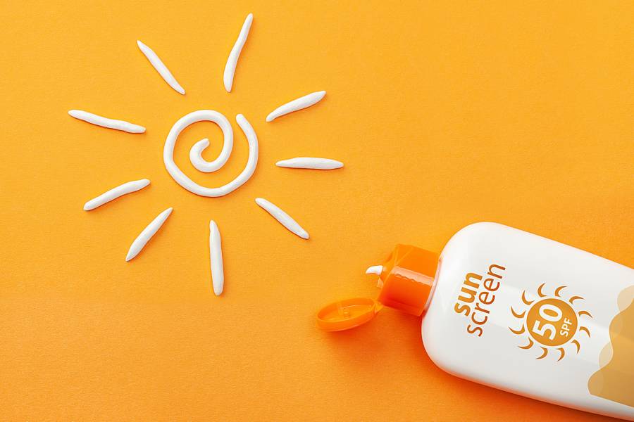 Bottle of sunscreen with a sun drawn in sunscreen