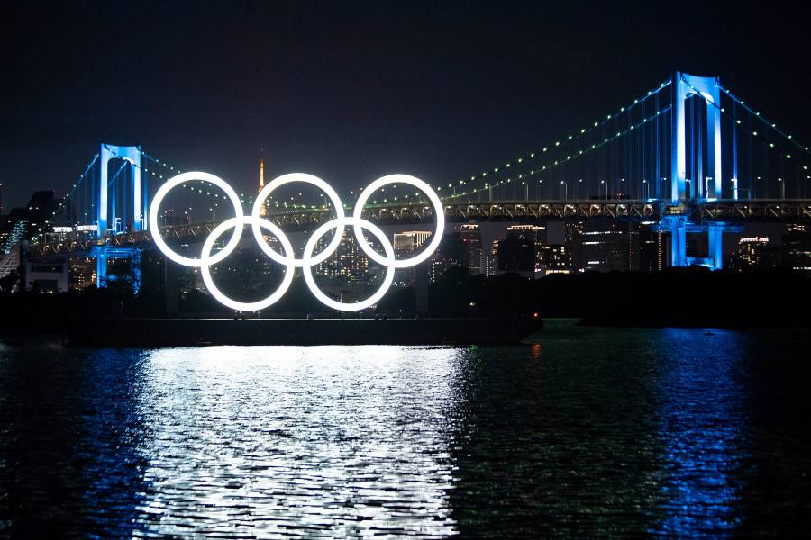 Olympic rings at night over water in Tokyo