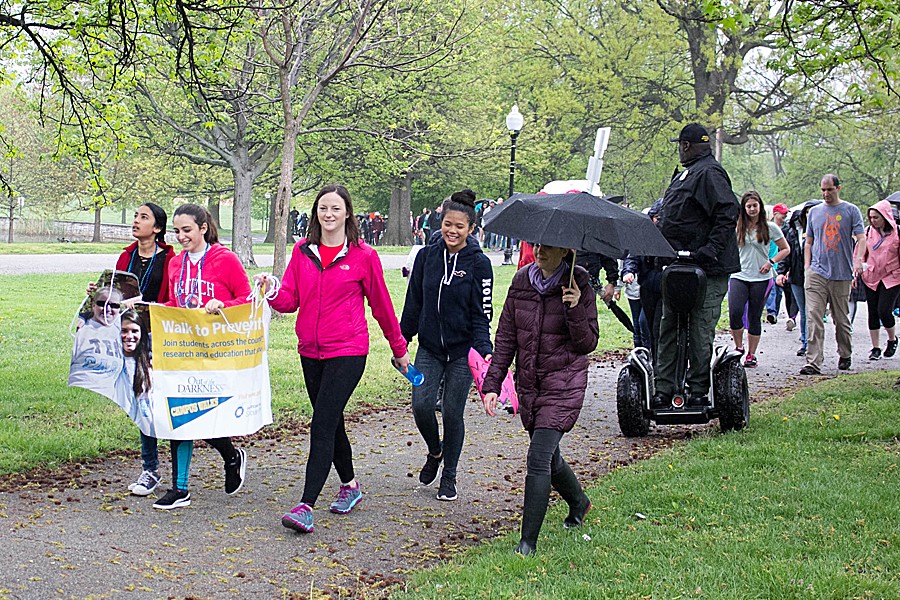 Nearly 100 people walk in the rain in the 2017 JHU Out of Darkness campus walk