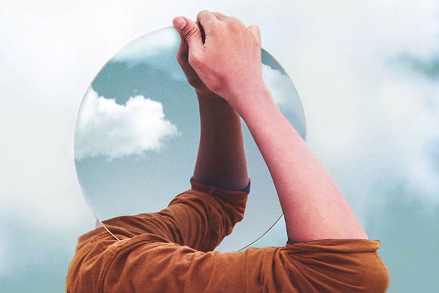 Photoshopped image of a man carrying a round mirror where his head should be