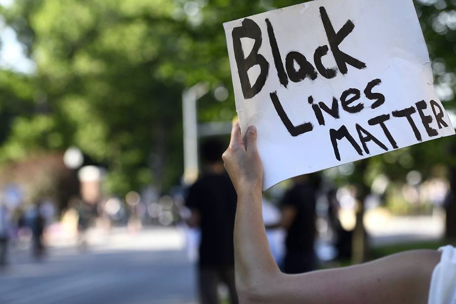 Person holds up 'Black Lives Matter' sign
