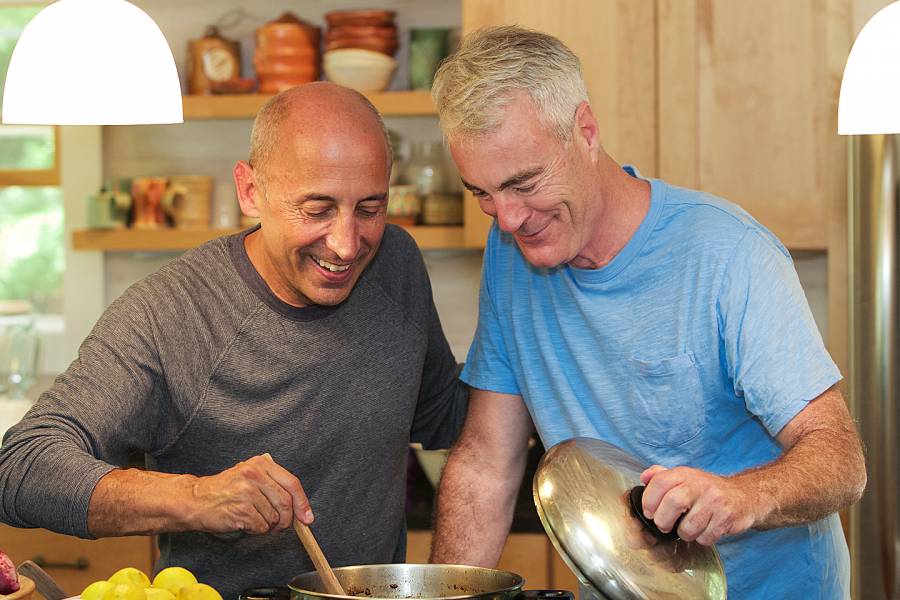 Two senior men enjoying cooking together