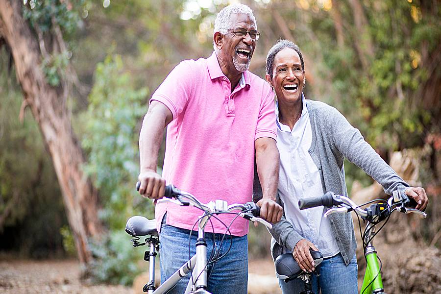 Mature man and woman riding bicycles