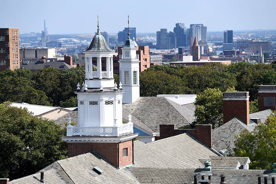 A rooftop view of Homewood campus buildings with the Baltimore skyline in the background