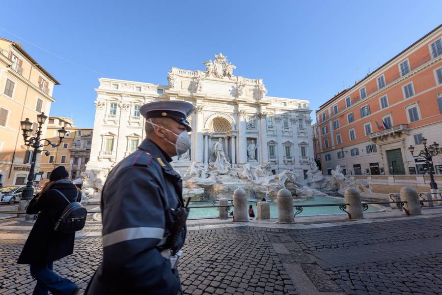 An Italian police officer patrols the Trevi Fountain in Rome
