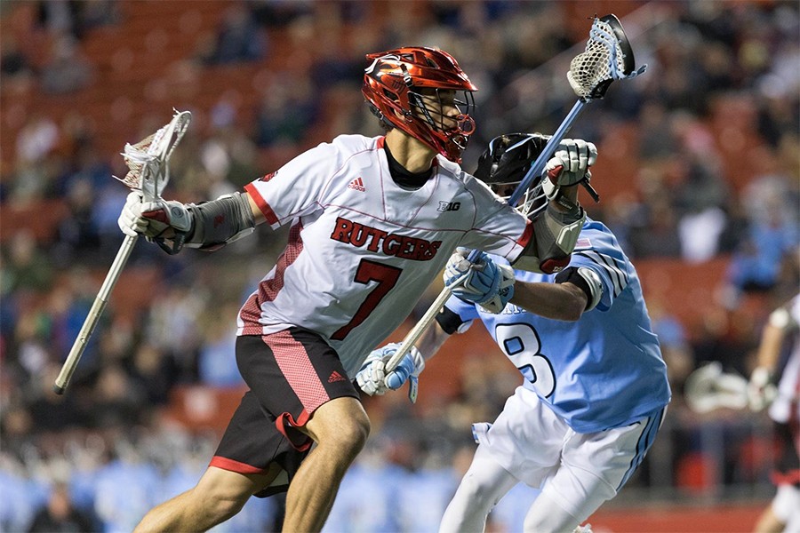A Rutgers lacrosse player goes to goal vs. Hopkins
