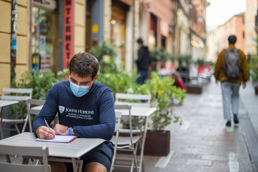 A student studies in a street cafe in Italy