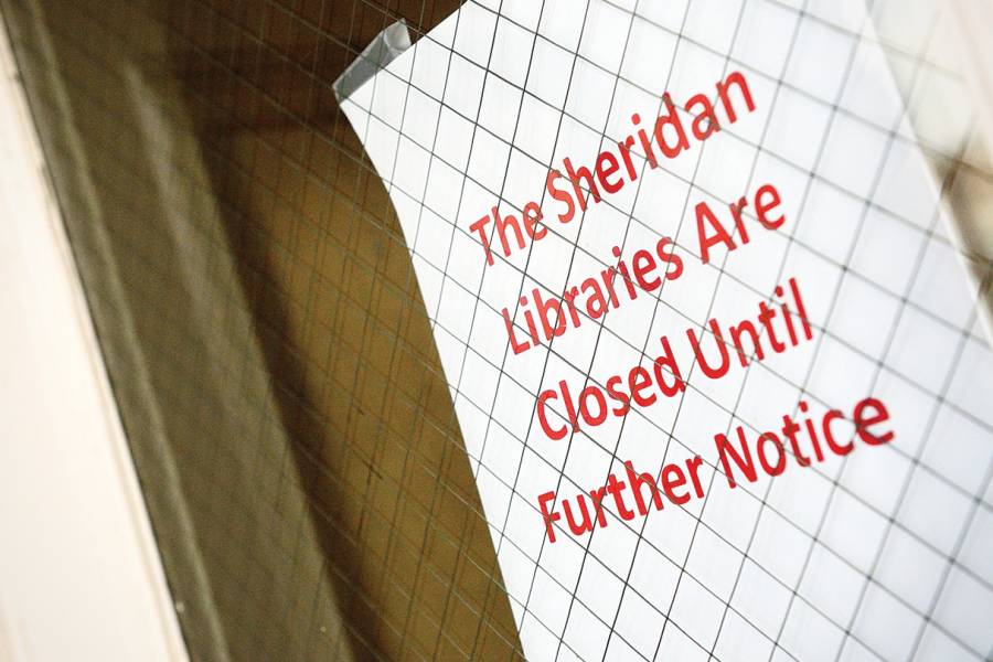 Sign reads Sheridan Libraries Closed Until Further Notice
