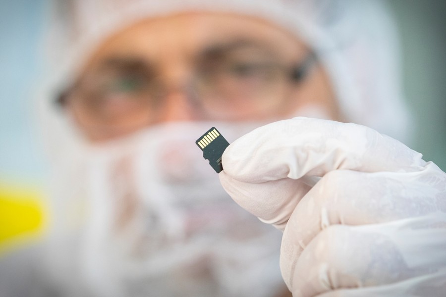 A scientist holds a microchip