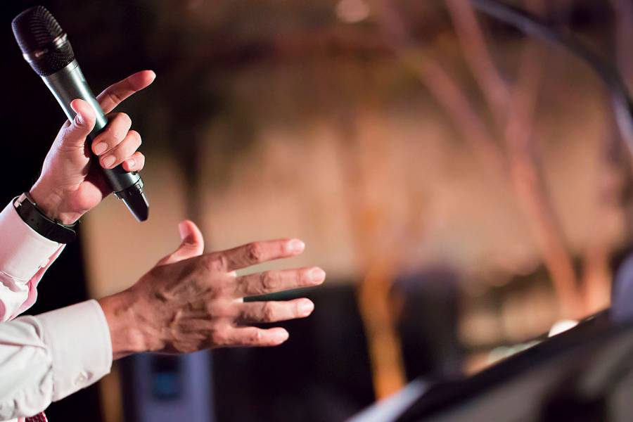 Man's hands holding a microphone