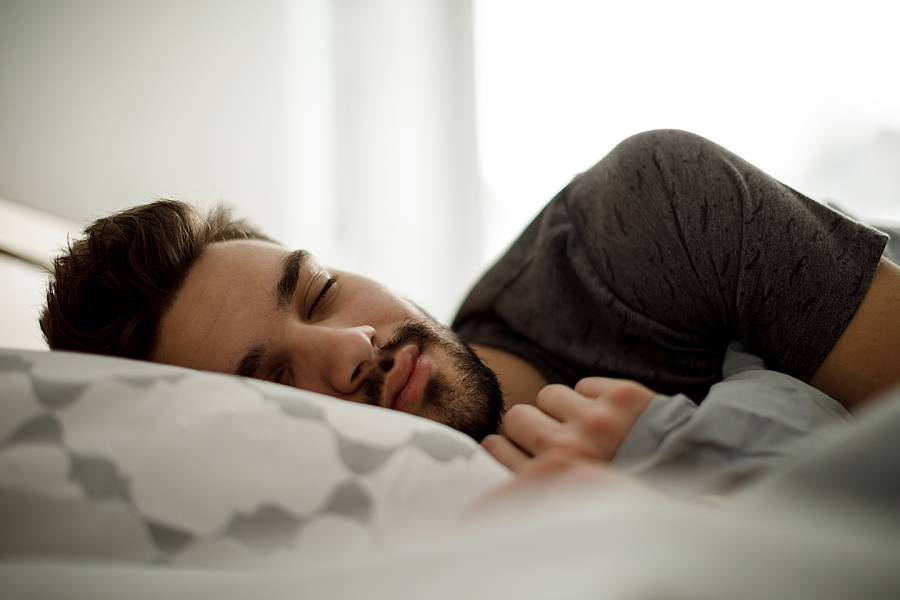 Man sleeping peacefully in bed at home