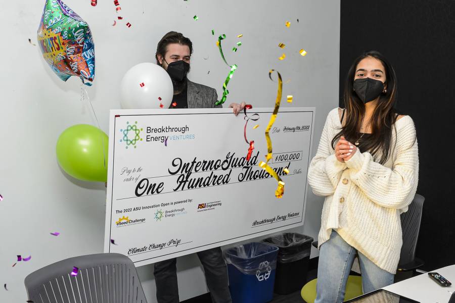 Nandita Balaji recieves a large novelty check written out to her company, InfernoGuard, for $100,000