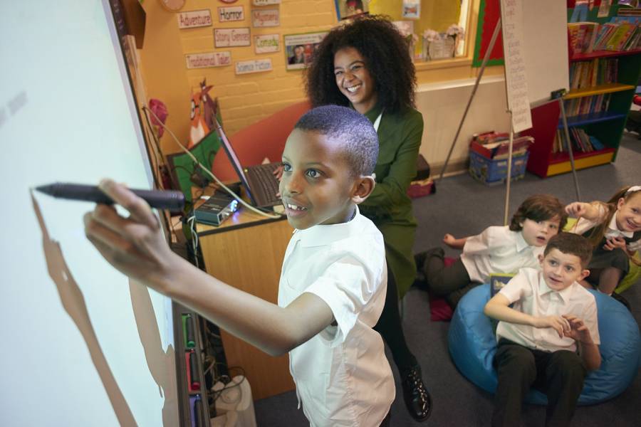 students writing on whiteboard