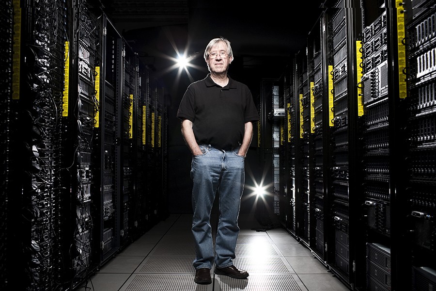 Alex Szalay stands in a dark server room