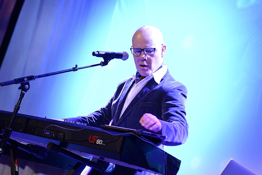 Thomas Dolby at keyboard with blue background