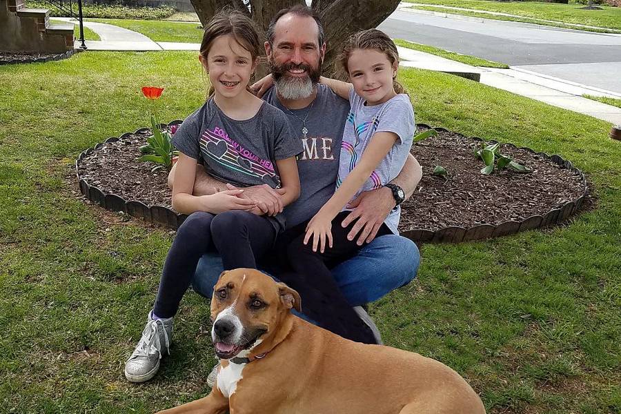 Tim Richardson with daughters Olivia and Lillian and family dog Sadie, at home in Catonsville