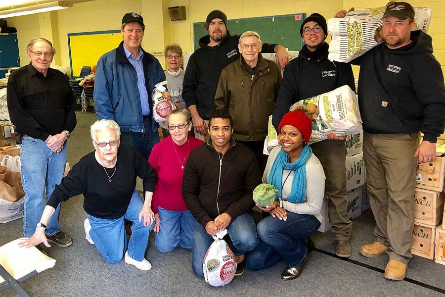 JHU employees join volunteers from St. Anthony of Padua to prepare holiday food packages for the 2018 Vernon Rice Memorial Holiday Turkey Program.