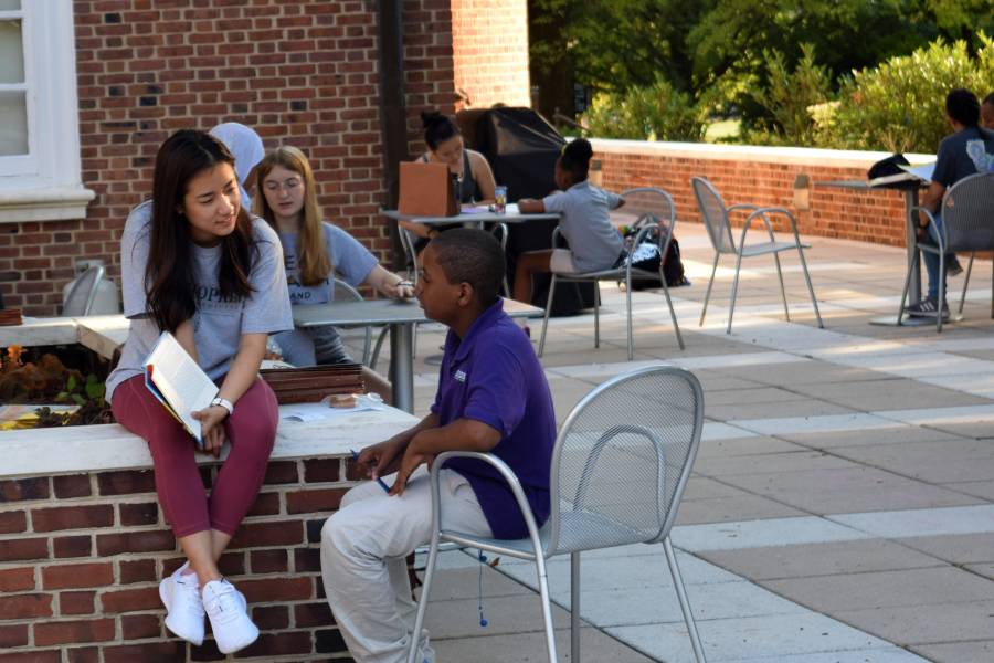 School kids and Johns Hopkins student tutors work together on Homewood campus