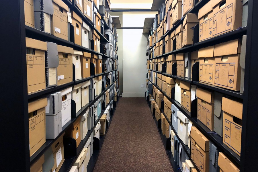 A row between two shelving units filled with boxes