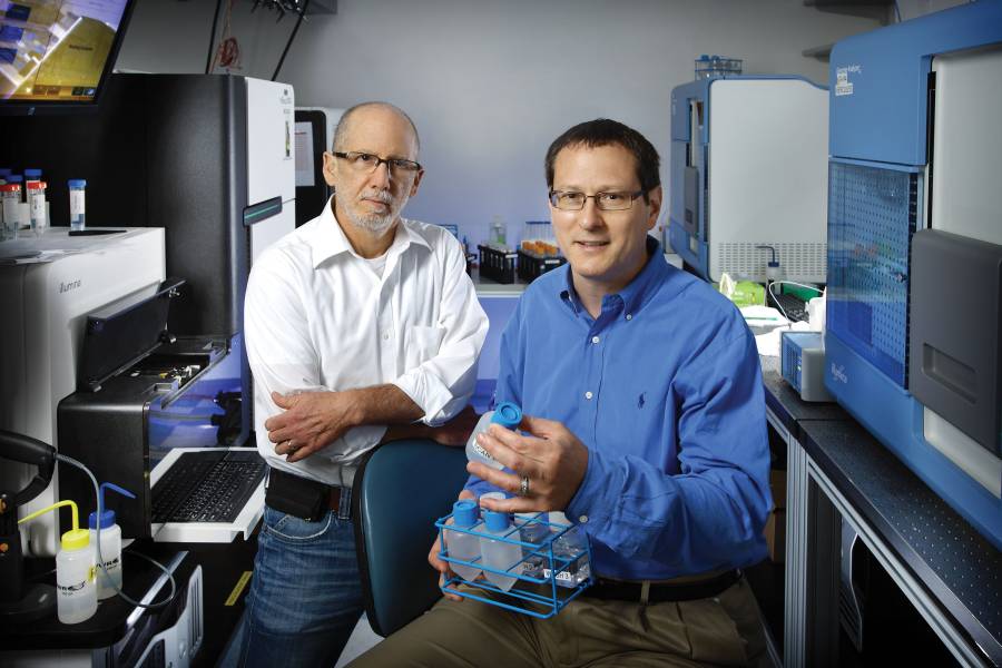 Bert Vogelstein and Ken Kinzler pose in a laboratory