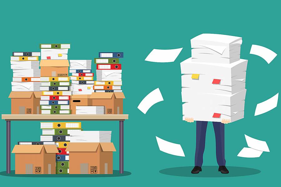 Illustration of desk covered with files and person holding pile of papers