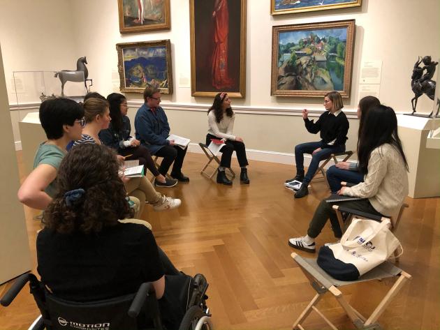 Students gather in a circle in chairs for a class meeting at the Baltimore Museum of Art