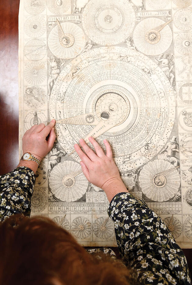 Rachel Williams, a Stern Center Curatorial Fellow, works with a 17th-century “paper supercomputer” created by Italian friar Vincenzo Maria Coronelli. By twisting its wheels, users can perform complex astrological and astronomical calculations, determine Catholic feast days, and more.