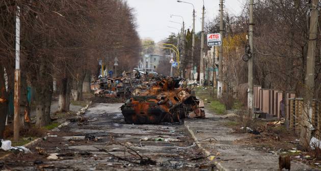 A destroyed tank and debris litters streets in Bucha after the Russian invasion of Ukraine