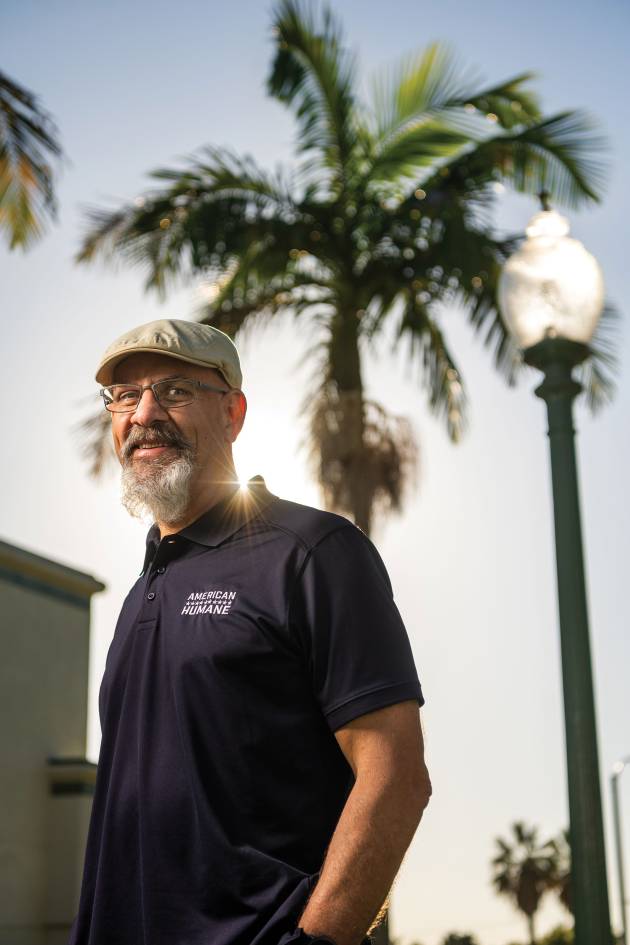 Thomas Edling poses in a polo shirt that has the American Humane logo