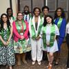 A group of 10 smiles for the camera while wearing green stoles that read "Bouchet Graduate Honor Society 2025."
